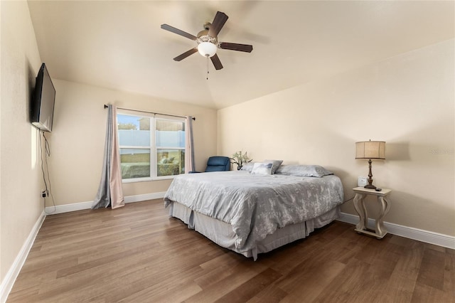 bedroom featuring hardwood / wood-style floors, ceiling fan, and vaulted ceiling