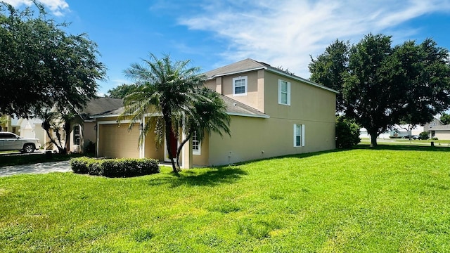 view of side of property featuring a yard and a garage