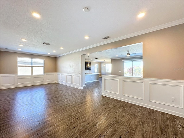 spare room with ceiling fan, sink, dark hardwood / wood-style floors, crown molding, and a textured ceiling