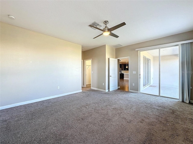 unfurnished bedroom with multiple windows, ceiling fan, carpet, and a textured ceiling