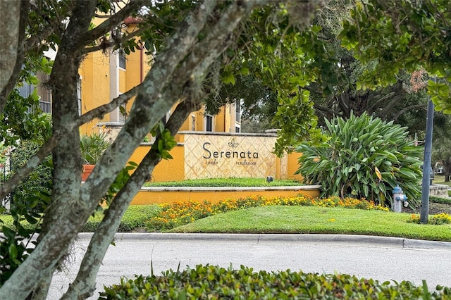 community / neighborhood sign with a lawn