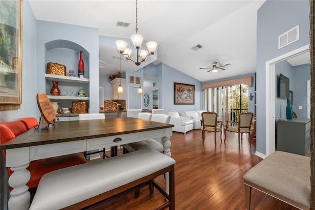 dining room featuring dark hardwood / wood-style floors, lofted ceiling, and ceiling fan with notable chandelier