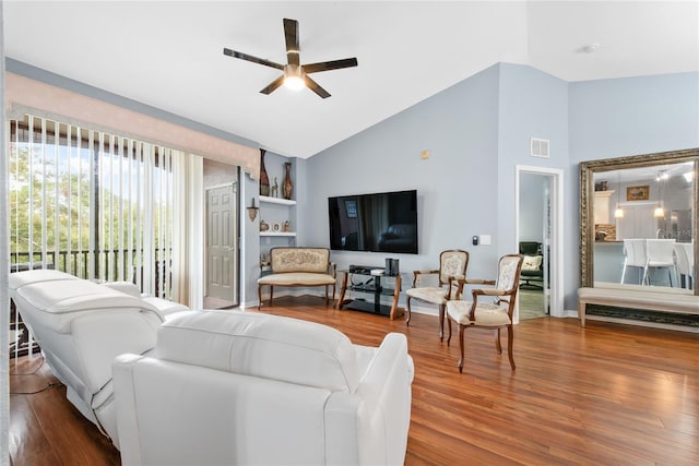 living room with hardwood / wood-style flooring, high vaulted ceiling, and ceiling fan