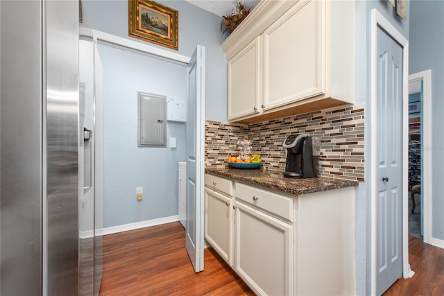 kitchen featuring electric panel, decorative backsplash, white cabinets, and dark wood-type flooring