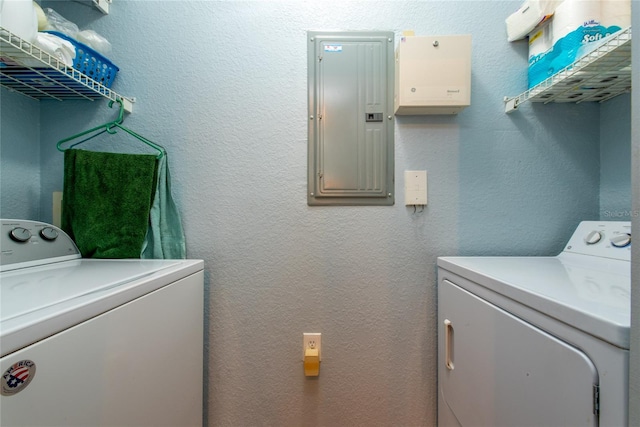 washroom with electric panel and washer and clothes dryer