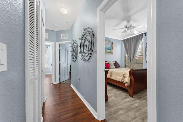 hall with dark wood-type flooring