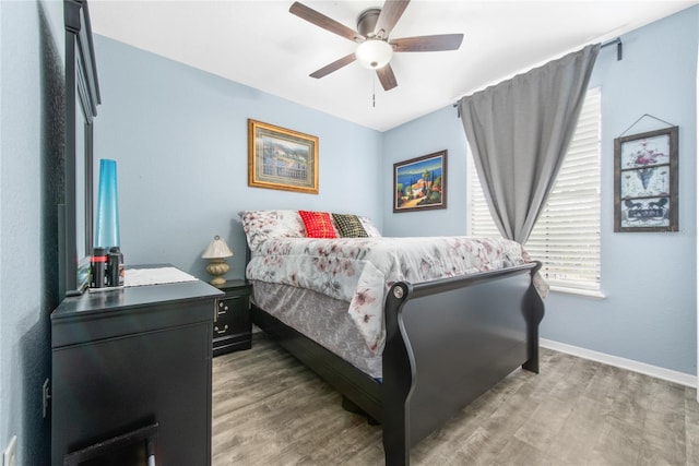 bedroom with ceiling fan and hardwood / wood-style floors