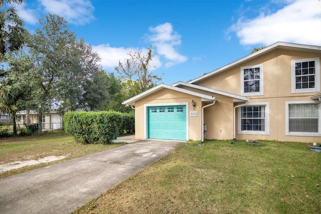 view of front of property featuring a front yard and a garage