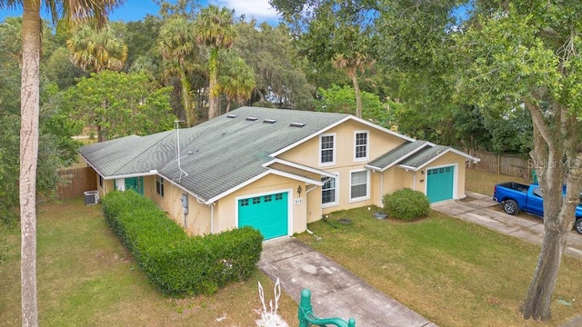 view of front of property with a garage and a front lawn