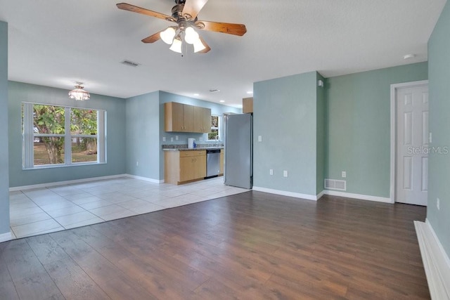 unfurnished living room with ceiling fan and light wood-type flooring