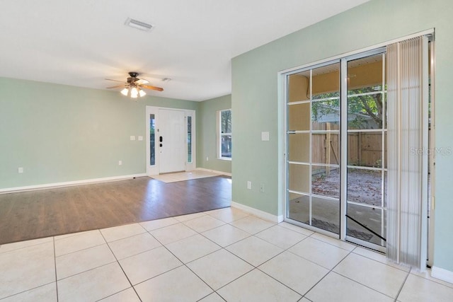 entryway featuring ceiling fan, light wood-type flooring, and a wealth of natural light