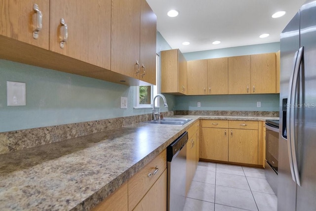 kitchen with light brown cabinetry, sink, stainless steel appliances, and light tile patterned flooring