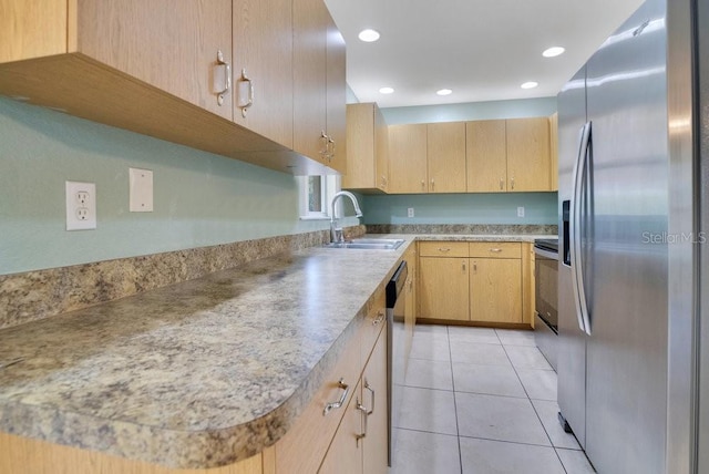 kitchen featuring sink, light brown cabinetry, light tile patterned floors, and appliances with stainless steel finishes