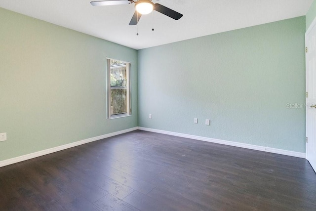 empty room featuring dark hardwood / wood-style flooring and ceiling fan