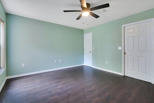 spare room featuring ceiling fan and dark hardwood / wood-style flooring