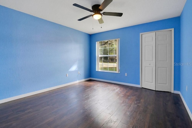 unfurnished bedroom featuring dark hardwood / wood-style floors and ceiling fan