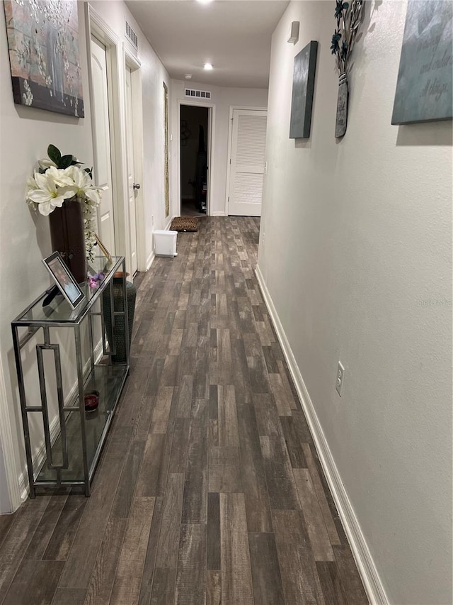 hallway featuring dark hardwood / wood-style flooring