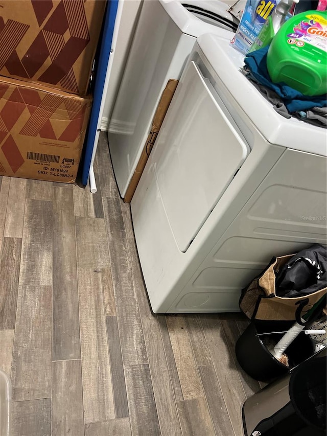 washroom featuring washer and dryer and wood-type flooring