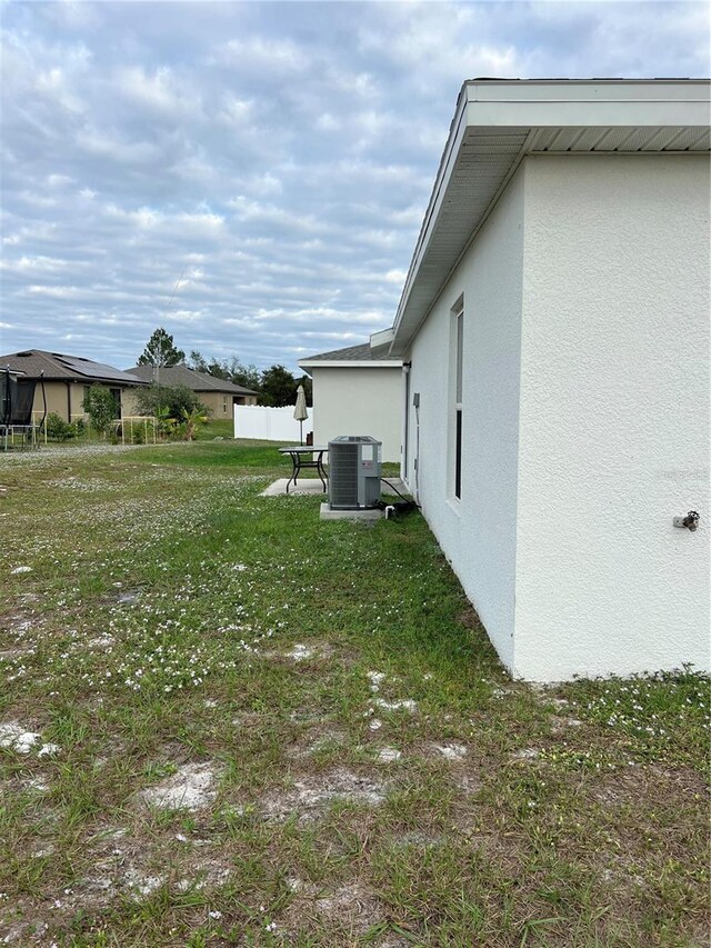 view of yard with central AC