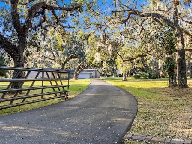 view of gate featuring a yard