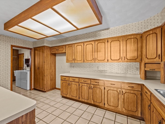 kitchen with light tile patterned flooring and washing machine and clothes dryer