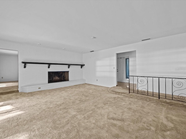 unfurnished living room featuring carpet floors