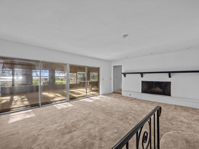 unfurnished living room featuring a fireplace and light carpet