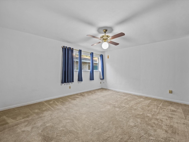 carpeted empty room featuring ceiling fan