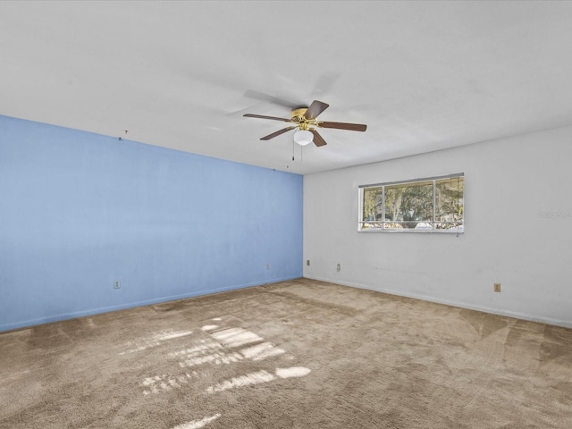 spare room featuring ceiling fan and carpet