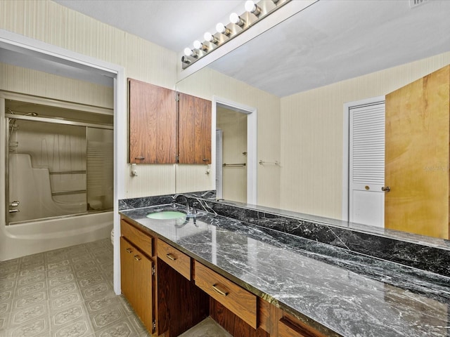 bathroom with vanity and bath / shower combo with glass door