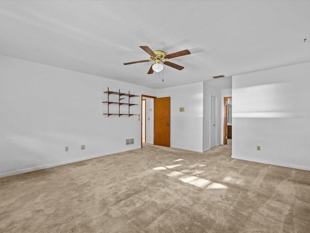 carpeted empty room featuring ceiling fan