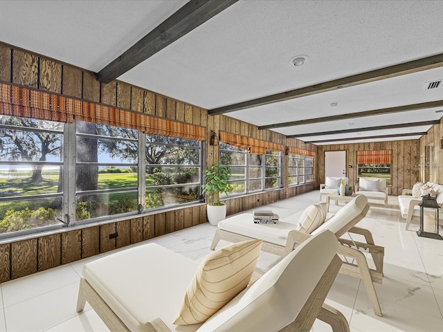 sunroom with beam ceiling and plenty of natural light