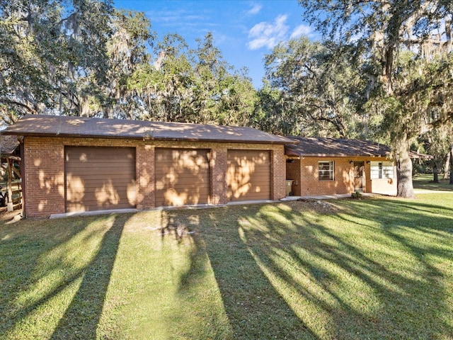 view of front of house with a garage and a front lawn