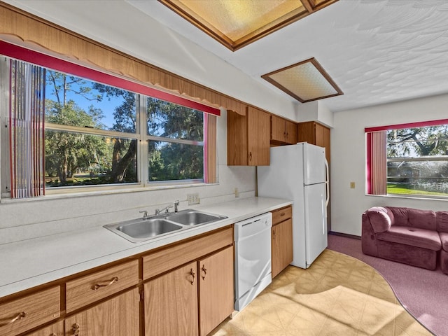 kitchen featuring white appliances and sink