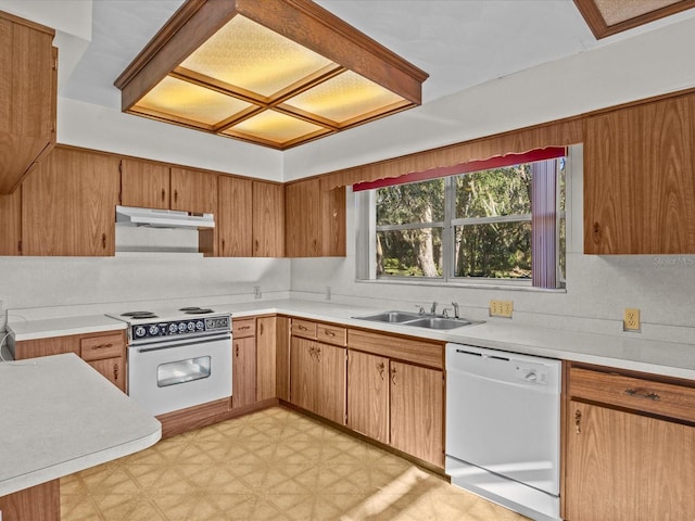 kitchen featuring decorative backsplash, white appliances, and sink