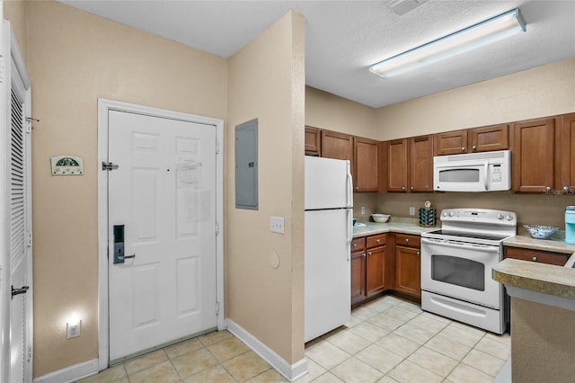 kitchen with a textured ceiling, electric panel, light tile patterned floors, and white appliances