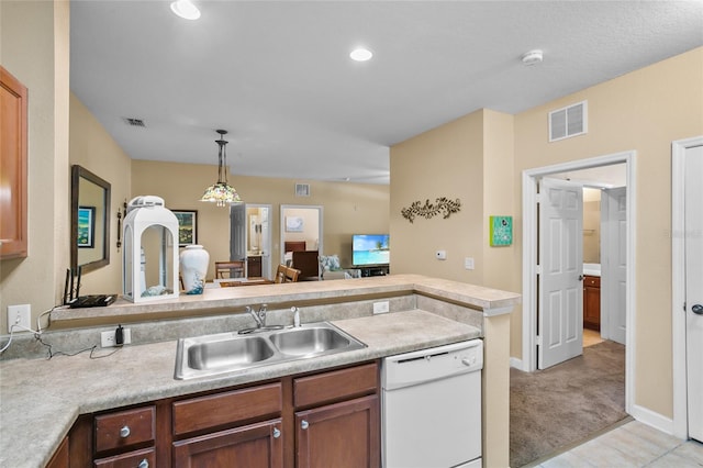 kitchen featuring pendant lighting, light carpet, white dishwasher, sink, and kitchen peninsula