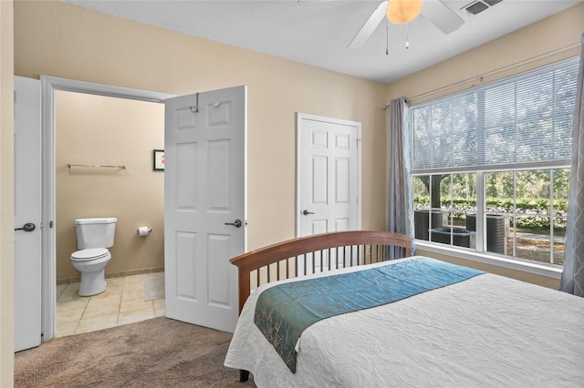 carpeted bedroom with ceiling fan and connected bathroom