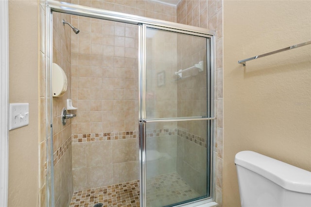 bathroom with toilet and walk in shower