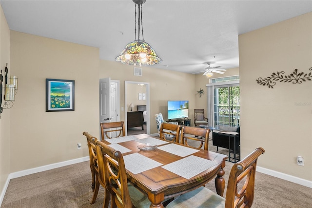 dining area featuring carpet and ceiling fan