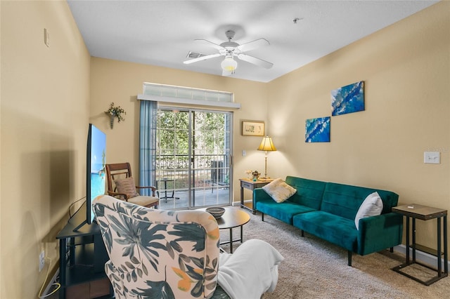 living room with ceiling fan and light colored carpet