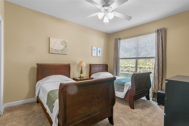 bedroom featuring light carpet and ceiling fan