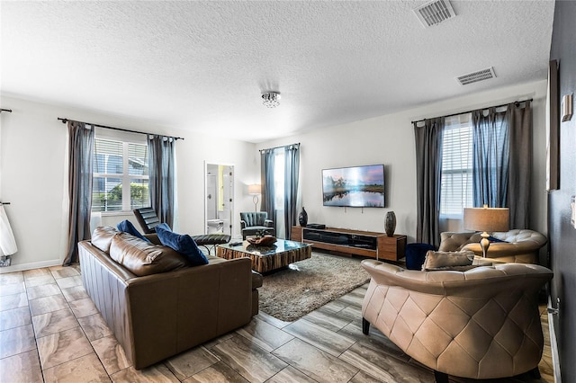 living room featuring a healthy amount of sunlight and a textured ceiling