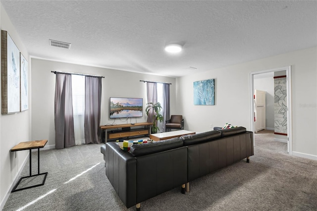 living room with a healthy amount of sunlight, light colored carpet, and a textured ceiling