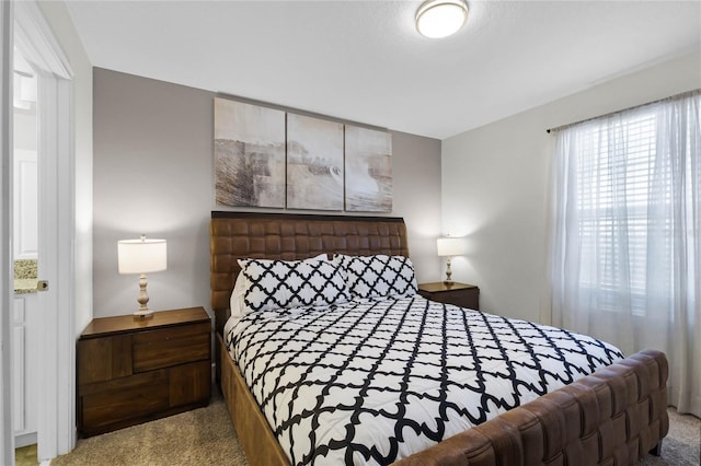 bedroom featuring light colored carpet