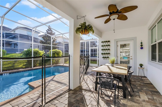 sunroom / solarium featuring ceiling fan and a swimming pool