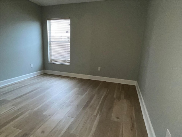 unfurnished room featuring hardwood / wood-style flooring