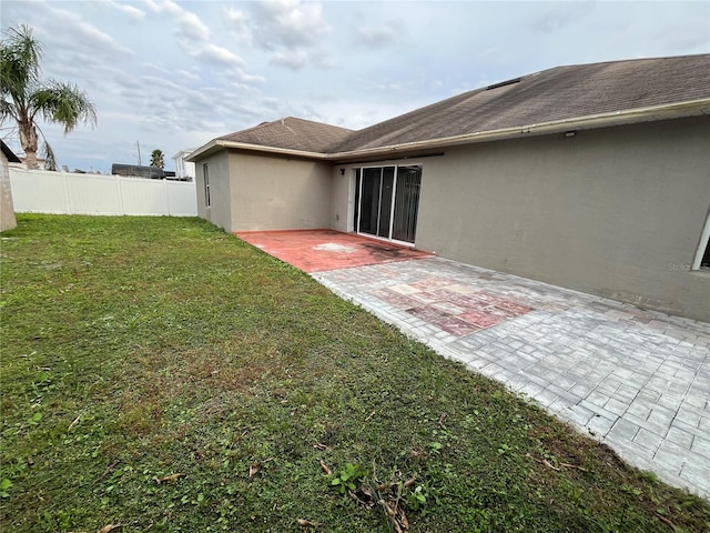 rear view of house with a patio area and a yard