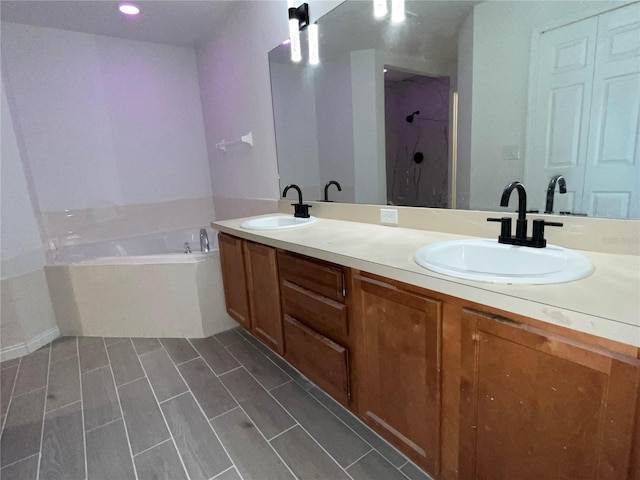 bathroom with shower with separate bathtub and vanity