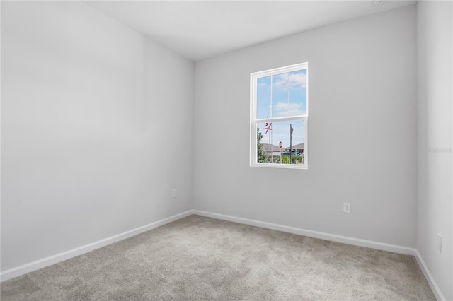 carpeted spare room with baseboards